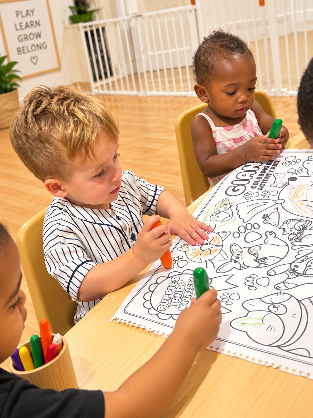 Children coloring a large animal activity page together at a classroom table