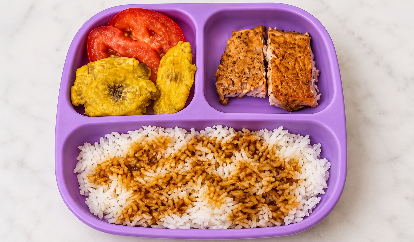 Salmon and rice with tomato and plantains served in a divided meal tray