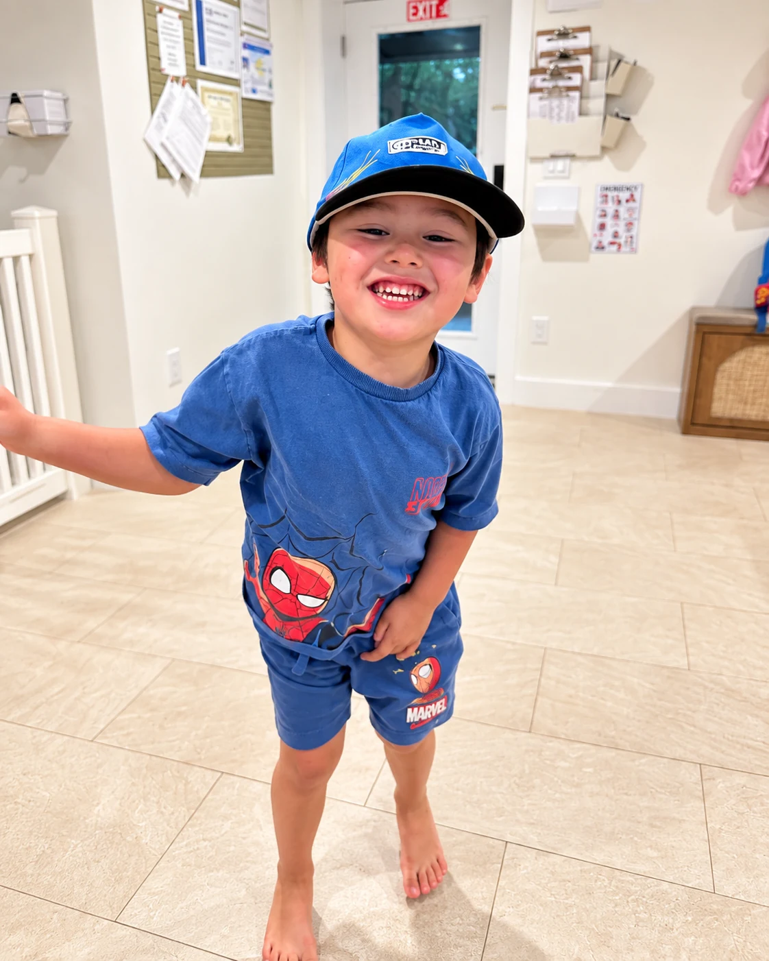 Child smiling during indoor play in the clubhouse hallway