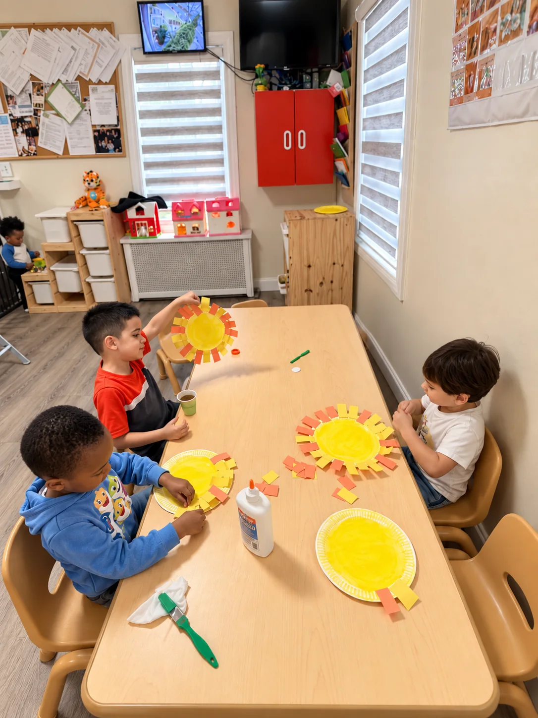 Children creating colorful paper-plate sun crafts together at a classroom table