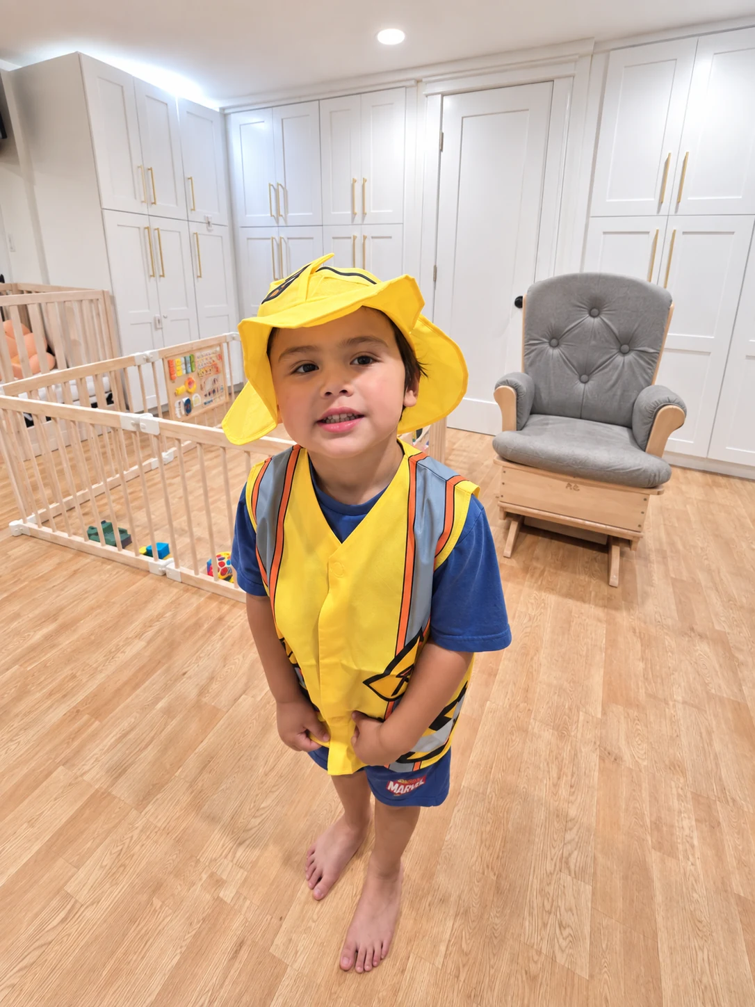 Child dressing up in a firefighter costume during indoor pretend play