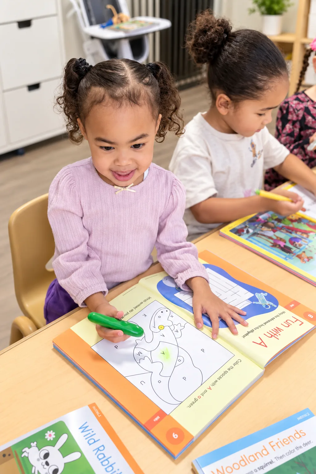 Two children coloring activity workbooks side by side at a classroom table