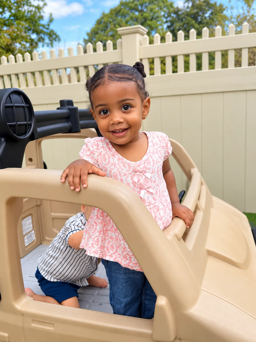 Smiling toddler exploring an outdoor play structure